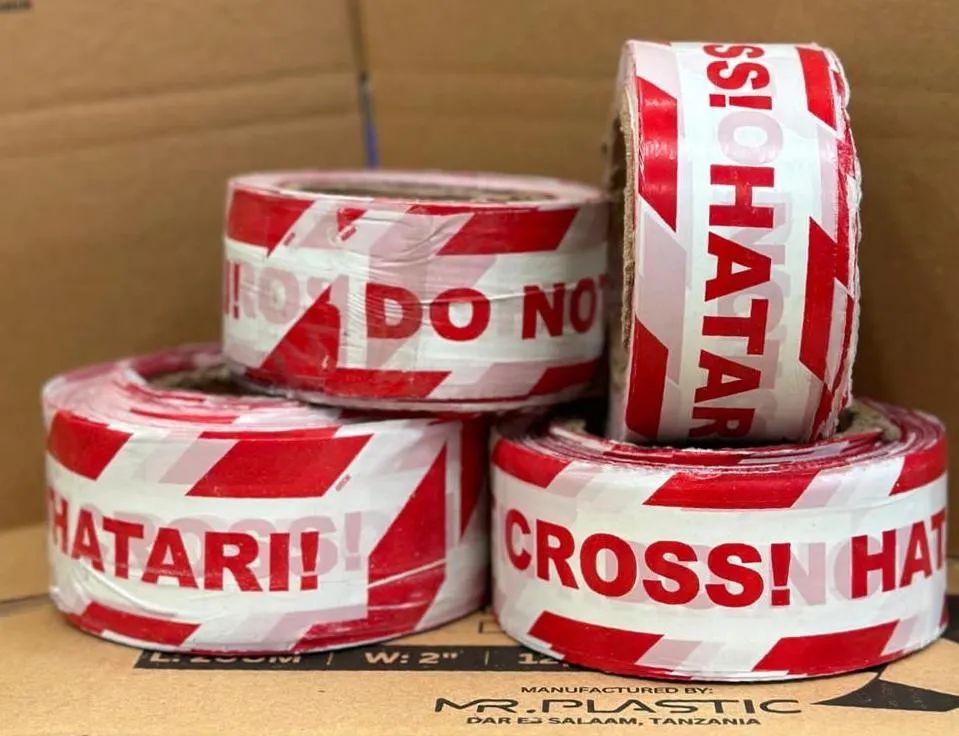 Red and white Do Not Cross Hatari tape rolls