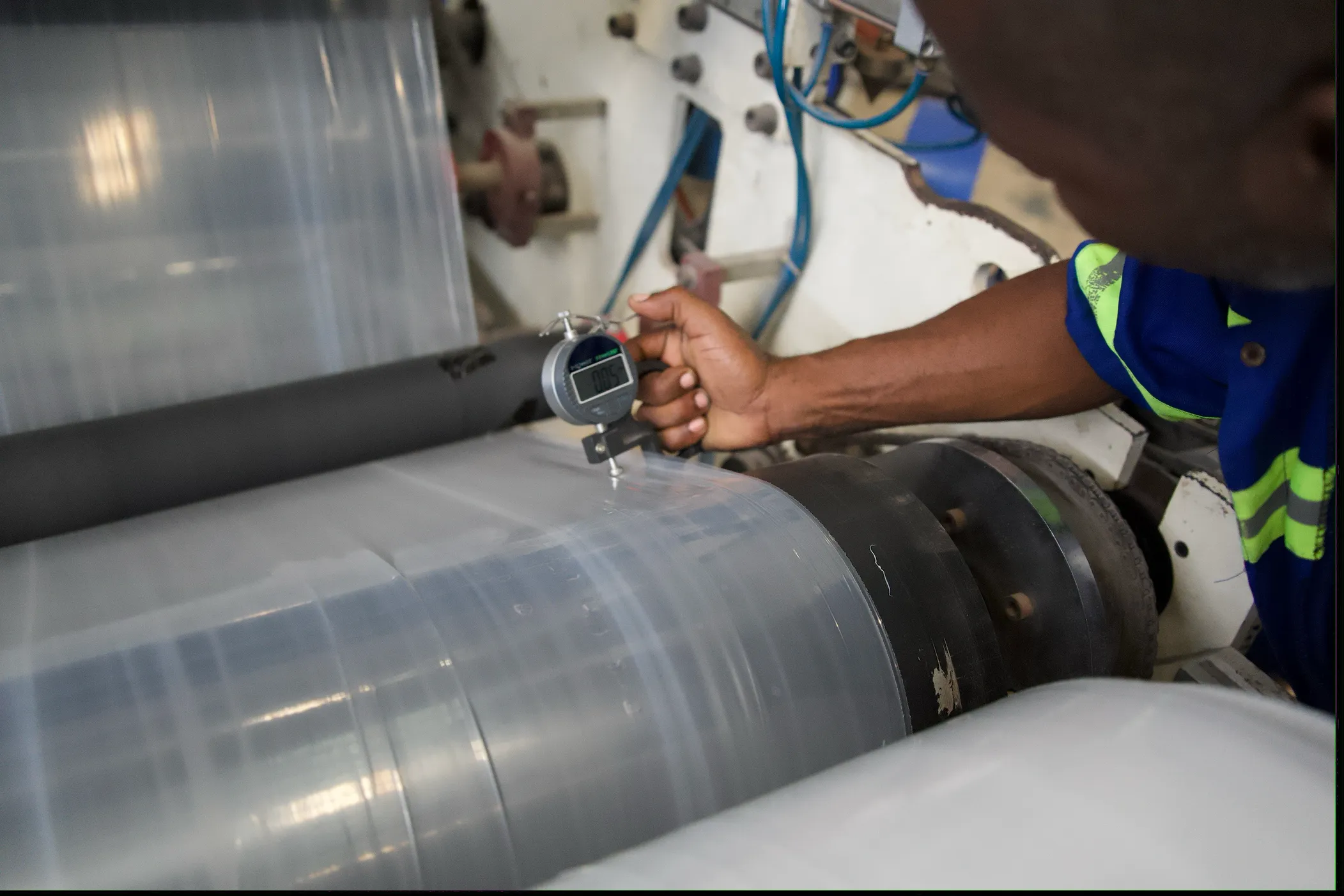 Film thickness being checked with a digital gauge on the production line